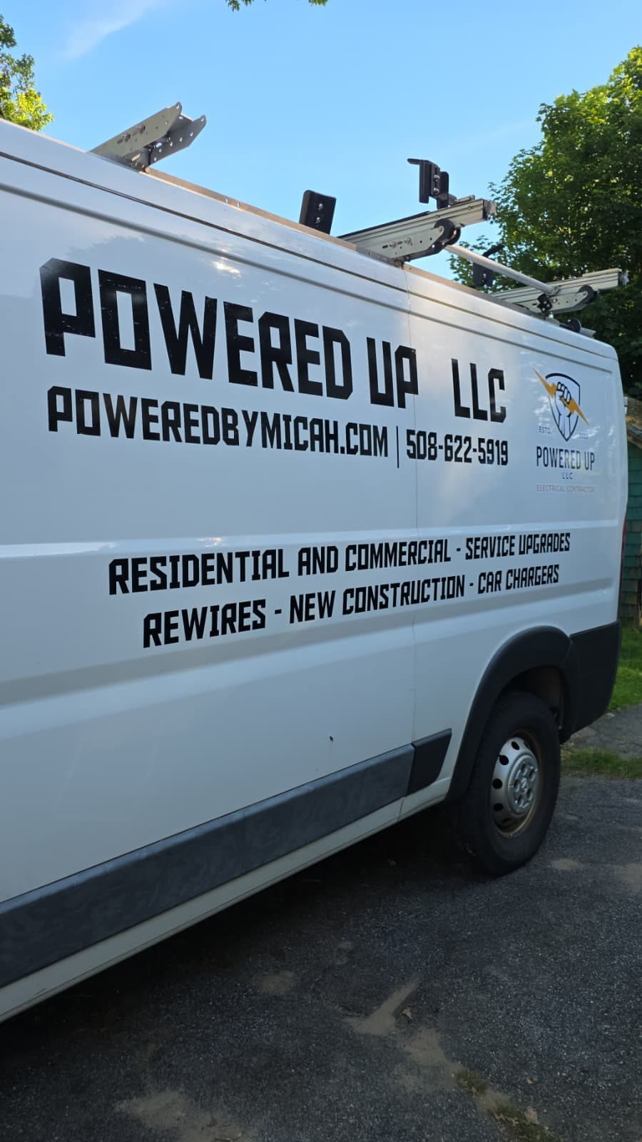 Powered Up LLC company van with branding and contact information